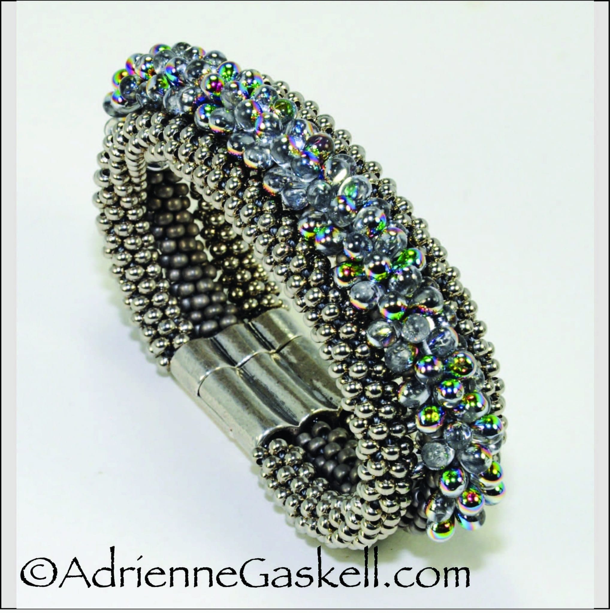 This project was featured in Bead & Button Magazine as Elegant Ombre Braids, December 2019. This bracelet achieves dimensional impact by stacking and then joining three separate braids together. Czech teardrop beads with a rainbow AB finish are the crowning glory.